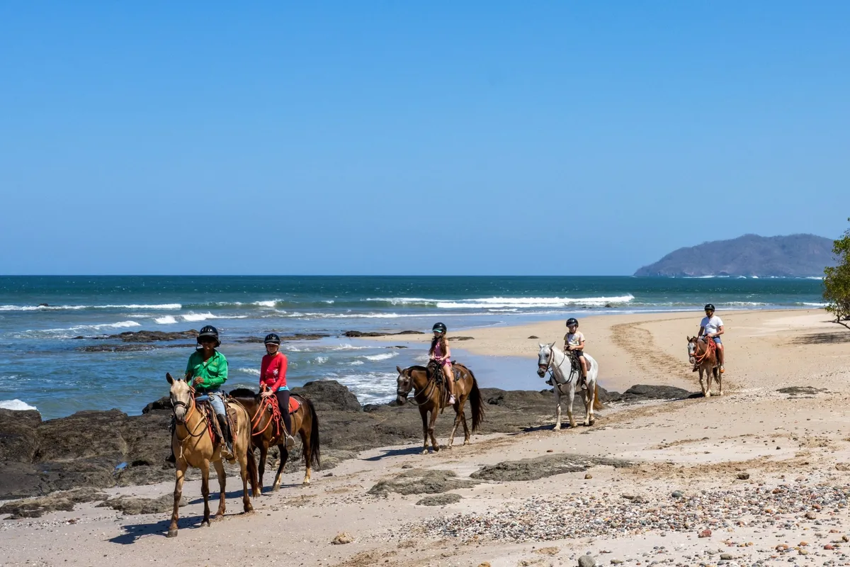 Horseback riding along the beach in Hacienda Pinilla